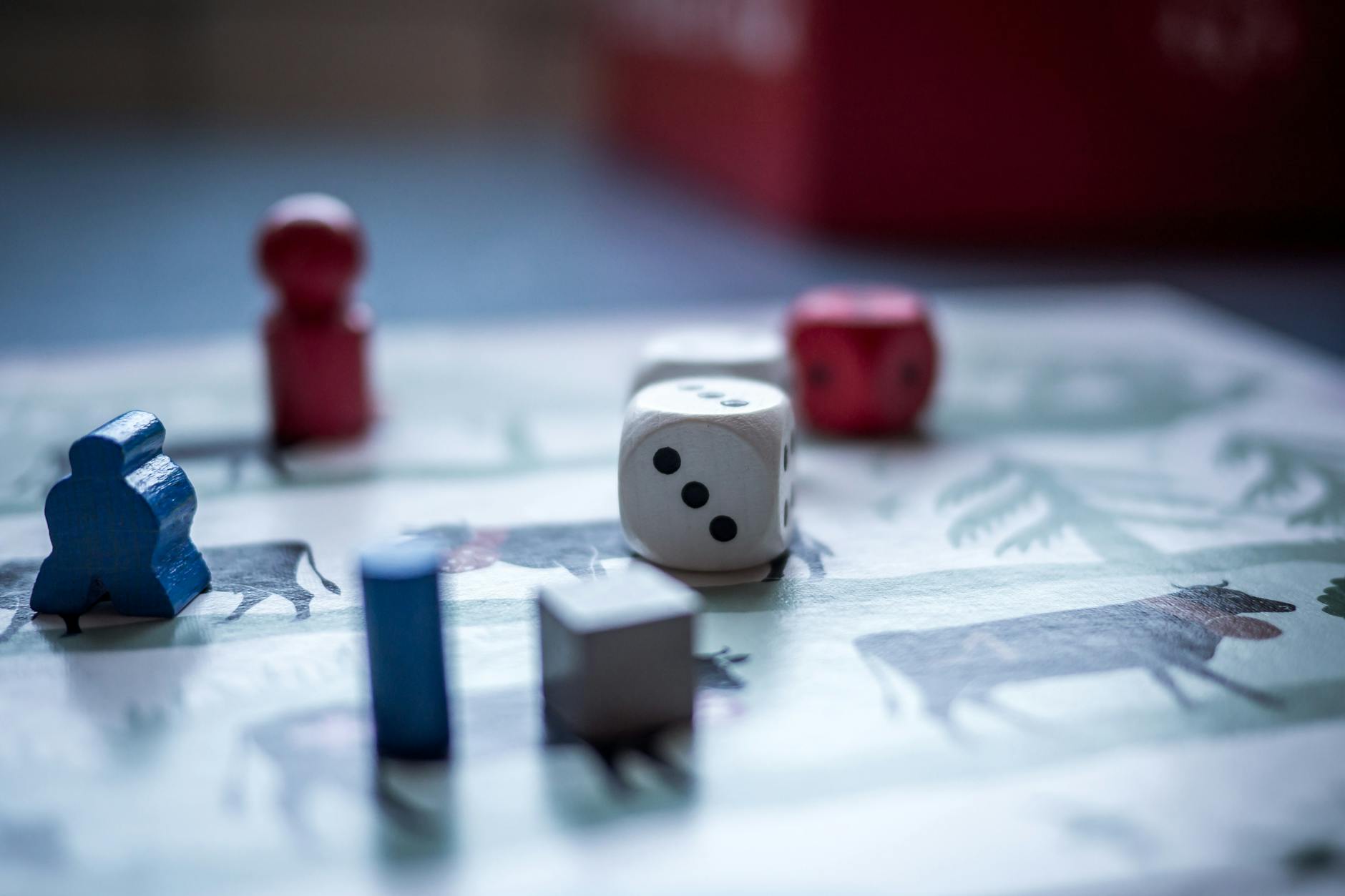 dices and wooden pieces on game board